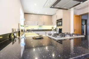 a large kitchen with a stove top oven at Seascape - 4 bed home in Bracklesham Bay in Chichester