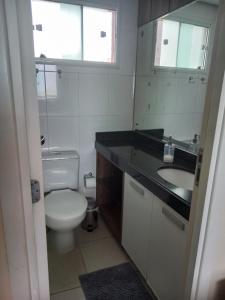 a bathroom with a toilet and a sink and a mirror at Dunna Barcane in Natal +20 photos