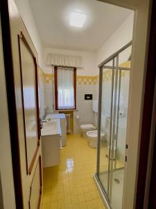a bathroom with a toilet and a sink and a shower at Angela Home in Rimini