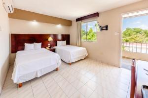 Postel nebo postele na pokoji v ubytování Hotel Maria del Carmen