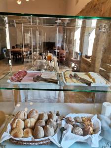 a display case filled with lots of different types of pastries at Casa Mindela Farmhouse in Vila do Conde