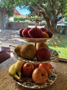 a bowl of fruit sitting on top of a table at Casa Mindela Farmhouse in Vila do Conde