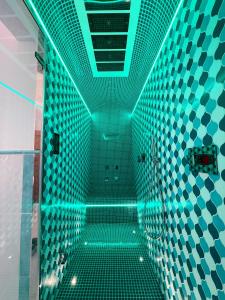 a pool with green lights in a bathroom at Villa Nettuno in Positano