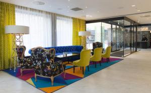 a lobby with chairs and a table in a building at Thon Hotel Rosenkrantz Oslo in Oslo