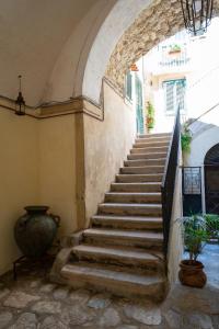 a stairway in a building with a stone stair case at SOGNI DA MARE in Tropea