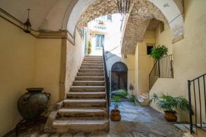 an archway with stairs in a building with potted plants at SOGNI DA MARE in Tropea