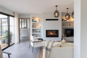 a living room with a white couch and a fireplace at La Maison des Embruns in Plouarzel