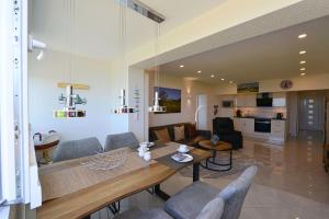 a dining room and living room with a table and chairs at Am Sahlenburger Strand AS05 in Cuxhaven