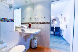 a bathroom with a sink and a toilet at Beach Lodge BL04 in Cuxhaven +22 photos