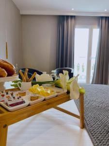 a tray of food on a table in a hotel room at Light Hotel in Tirana