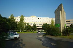 a parking lot in front of a large building at Kolej Akademie in Brno