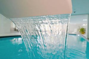 a water fountain in a swimming pool at Strandhochhaus SD06 in Cuxhaven +23 photos