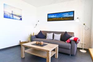 a living room with a couch and a coffee table at Strandhochhaus SD09 in Cuxhaven