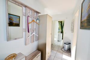 a hallway of a house with hangers on the wall at Haus Horizont H14B in Cuxhaven +23 photos