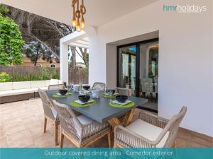 a dining room with a table and chairs at Villa Milana by HMR Holidays in Moraira