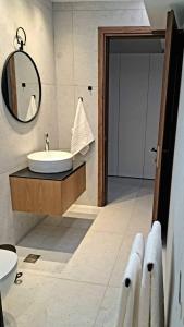 a bathroom with a sink and a mirror at Courtyard Luxury Suites “ APOSTOLOS” in Pefki Rhodes