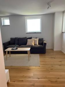 a living room with a couch and a coffee table at Elme apartment in Växjö