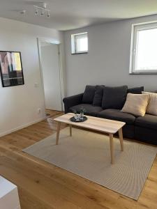 a living room with a couch and a coffee table at Elme apartment in Växjö