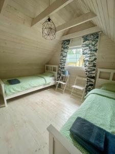Una cama o camas en una habitación de Ustronie Leśne 2
