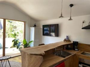 a kitchen with a wooden counter top and a sink at Arthouse Lola in Bergen