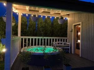 a patio with a hot tub on a deck at night at Zielona Kwatera in Polańczyk