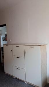 a white cabinet with drawers on top of it at For rest Hostel in Lublin