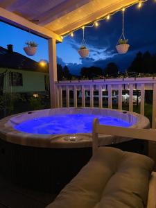 a hot tub on a deck at night at Zielona Kwatera in Polańczyk