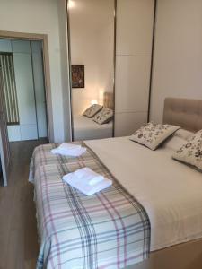 a bedroom with two beds with towels on them at Harmony Tivat Apartment in Tivat