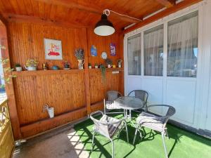 a patio with a table and chairs on a porch at Apartman Megolina in Varaždin