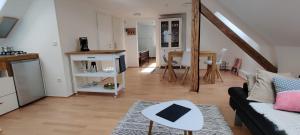 a living room with a couch and a table at Tinyloft in Beerfelden