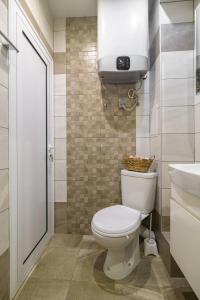 a bathroom with a toilet and a sink at Chayka Comfort Apartment in Varna City +11 photos