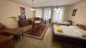 a living room with a bed and a dining room at Pension Pod Radnicí in Český Krumlov