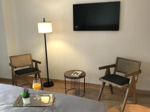 a room with two chairs and a television on the wall at HOTEL MONTE PERDIDO in Bielsa
