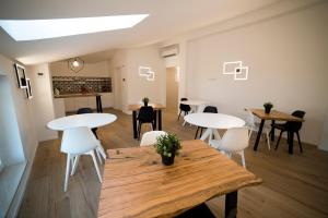 a room with two tables and white chairs at La Promessa in Santa Maria Nuova