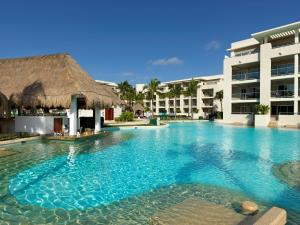 a swimming pool in front of a resort at Paradisus Playa del Carmen - Riviera Maya - All Inclusive in Playa del Carmen