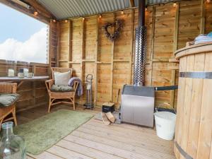 a wooden cabin with a table and chairs in it at Heather Hut at Copy House Hideaway in Barnoldswick