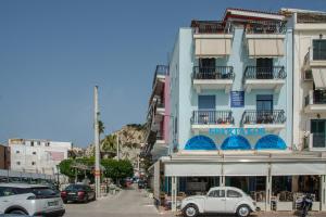 a white car parked in front of a building at Saint Loukas Studios in Zakynthos +45 photos