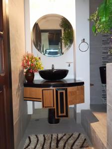 a bathroom with a sink and a mirror at Home Mark Casa Boutique in Paipa