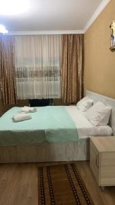 a bedroom with a large bed and a window at Hostel Saba in Kutaisi