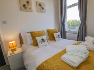 a bedroom with a bed with white sheets and pillows at Cliff House in Saltburn-by-the-Sea