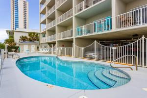 a swimming pool in front of a apartment building at Tropic Isl 501 in Gulf Shores