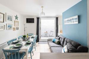 a living room with a table and a couch at Seabreeze - Norfolk Holiday Properties in Gorleston-on-Sea
