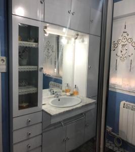 a bathroom with a sink and a mirror at Casa la Torre in Cambados