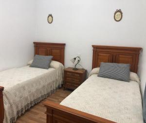 two beds sitting next to each other in a room at Casa la Torre in Cambados