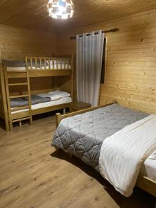 a bedroom with two bunk beds in a cabin at Guesthouse Demushi in Valbonë