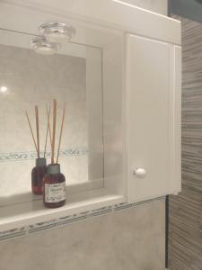 a white cabinet with a mirror in a bathroom at Monoambientes in Villa Alsina +14 photos