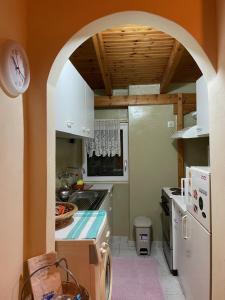 a kitchen with an archway in the middle at Maria`s Haus in Artemida in Artemida
