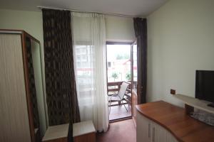 a living room with a sliding glass door to a balcony at Casa Teju in Slănic