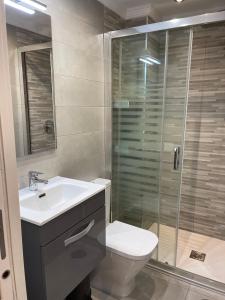a bathroom with a toilet and a sink and a shower at La Cala Holiday Retreat in La Cala de Mijas
