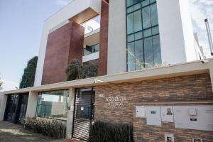 a building with a sign on the front of it at Smart Studio Cataratas Luxo in Foz do Iguaçu